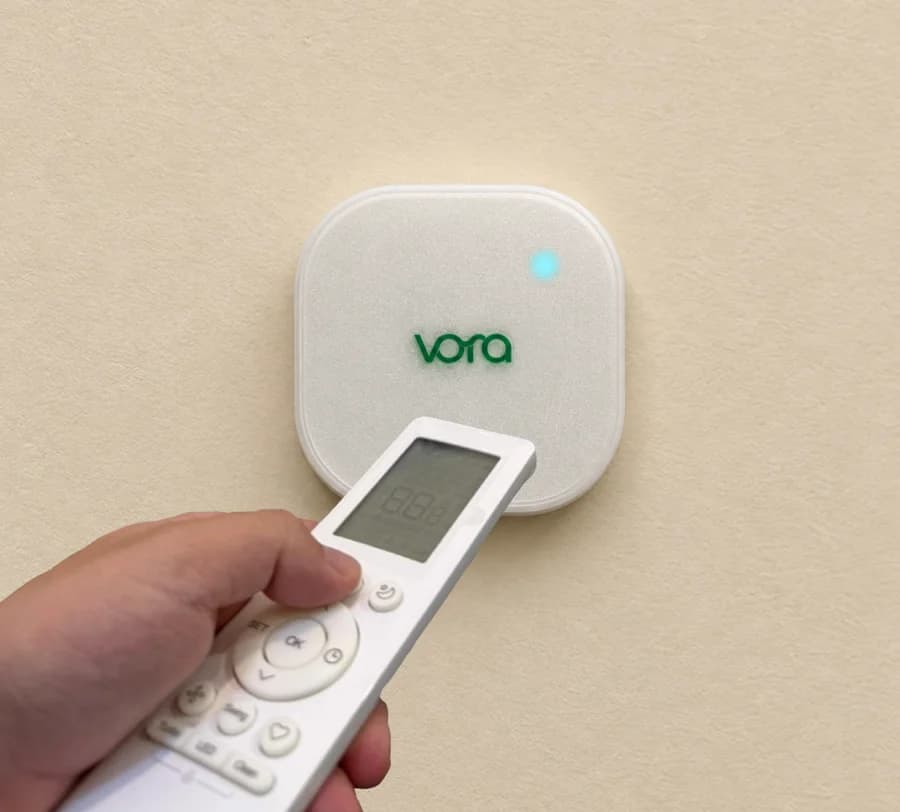 Step 2: pointing the AC’s own remote at the device to pair it